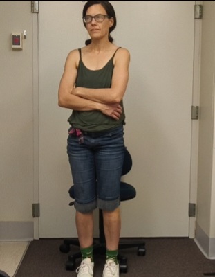 I'm standing with arms crossed looking grumpy.